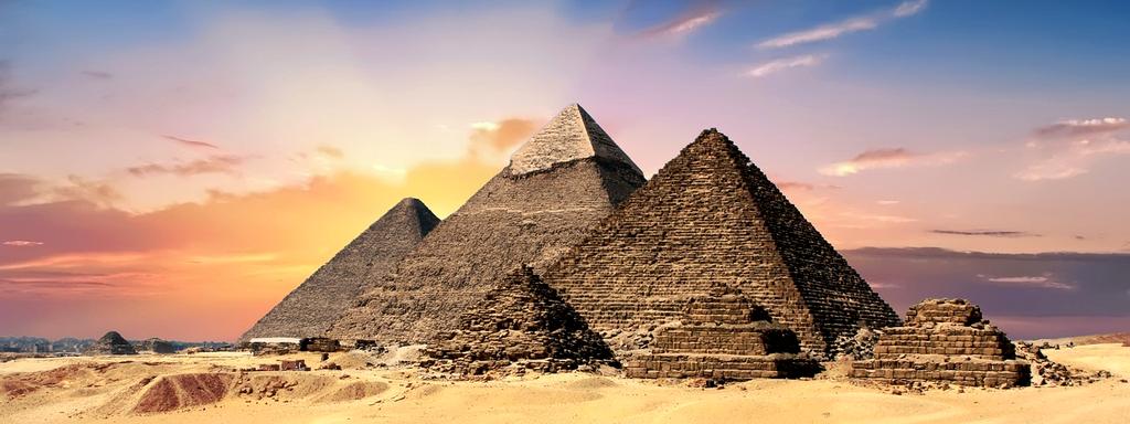 Sleek desert domes with solar panels during sunset